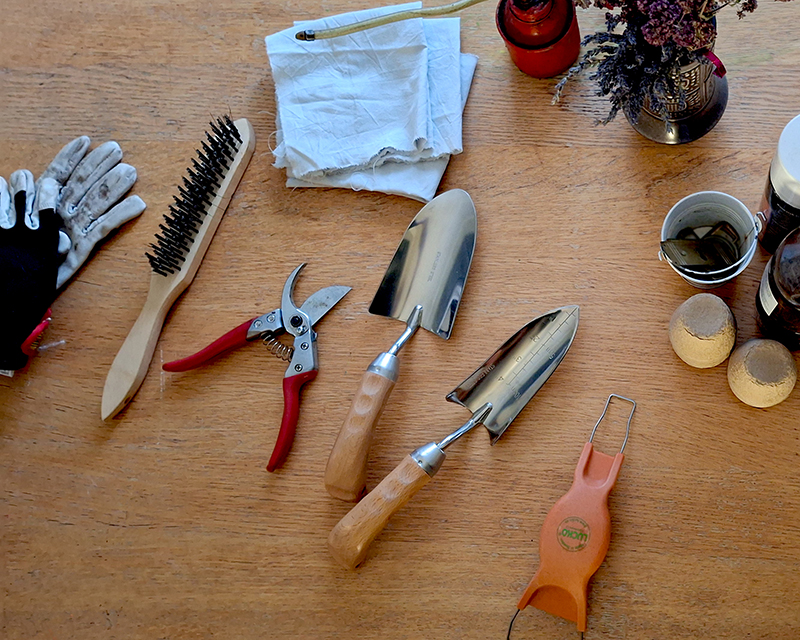 Olika tr&auml;dg&aring;rdsredskap p&aring; ett bord, f&ouml;rberedelse f&ouml;r reng&ouml;ring och inoljning